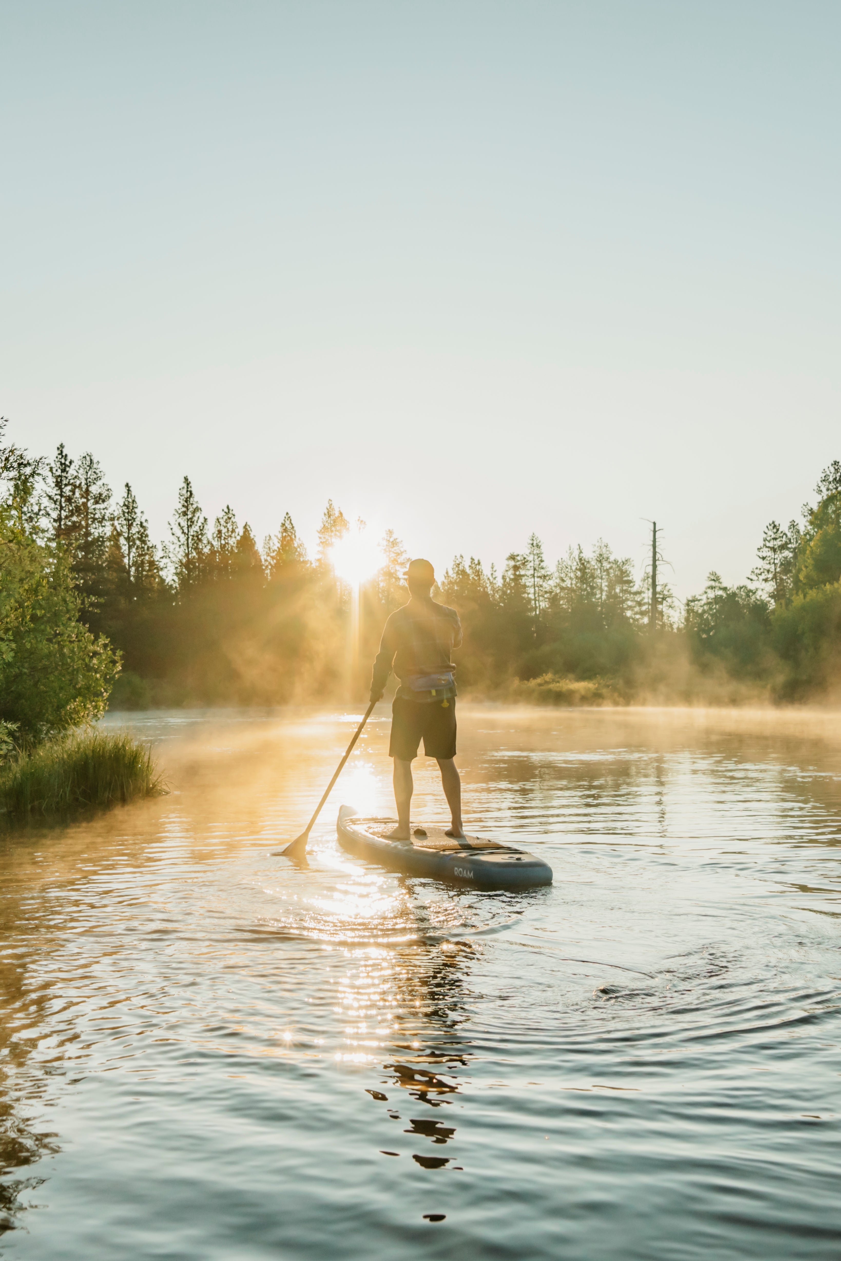 man paddle boarding in the sun